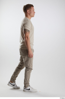Gilbert 1 dressed grey t-shirt grey trousers side view walking…